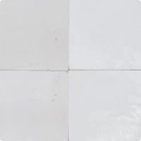 four square white tiles arranged in the same pattern