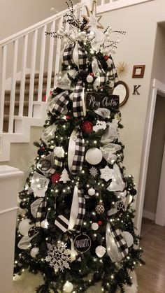 a christmas tree decorated with black and white ornaments