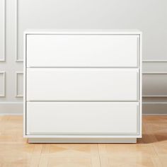 a white dresser sitting on top of a hard wood floor