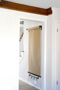 an open door with a towel hanging on the wall