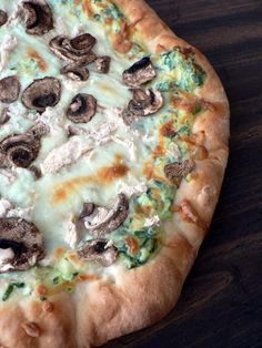 a pizza with mushrooms and cheese on it