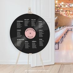 a vinyl record is on display in front of a wall with an event seating chart