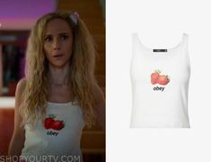 a woman wearing a white tank top with strawberries on it