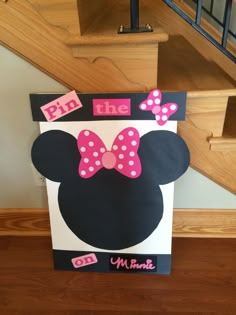 a cardboard sign with minnie mouse ears on it