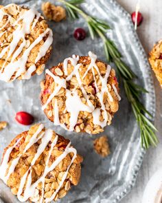 three cranberry oatmeal muffins with icing on top