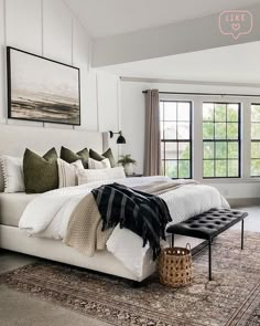 a large bed sitting in the middle of a bedroom