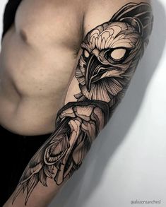 a man's arm with an owl and flower tattoo on the left side of his body