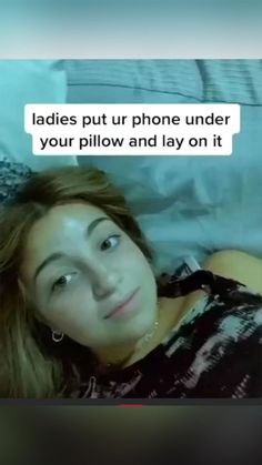 a woman laying on top of a bed next to a white pillow and texting that reads ladies put ur phone under your pillow and lay on it