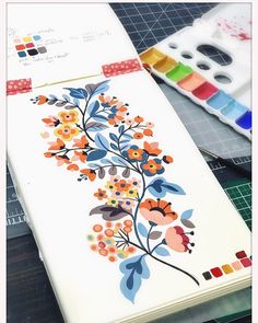 an open notebook with flowers painted on it