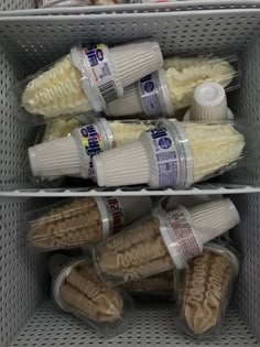 several plastic containers filled with food on top of a metal shelf in a grocery store