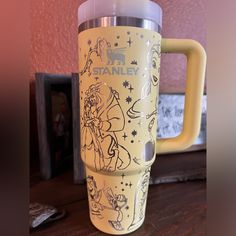 a yellow starbucks cup sitting on top of a wooden table