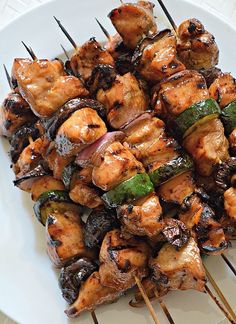 chicken and vegetable skewers on a white plate