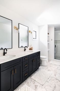 a bathroom with two sinks and mirrors on the wall