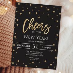 a black and gold new year's eve party card with stars on the front