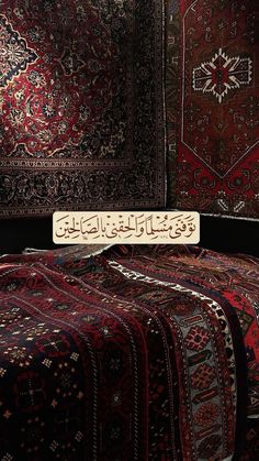 an array of rugs with arabic writing on one side and another in the other