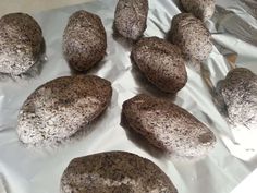 chocolate donuts sitting on top of aluminum foil