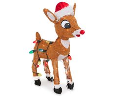 a toy deer with a santa hat on it's head is standing in front of a white background