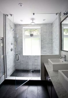 a bathroom with two sinks and a shower