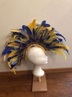 Do you want to be a showstopper at the party? This headpiece is perfect for you! Fun Summer Party Headpiece, Blue Headpieces For Carnival, Blue Costume Hats And Headpieces For Carnival, Fitted Headpieces For Mardi Gras Party, Yellow Party Headband Costume Accessory, Gold Headpieces For Party And Festival, Blue Feathered Headpiece For Party, Yellow Fitted Costume Hats And Headpieces For Party, Fitted Yellow Party Costume Hats