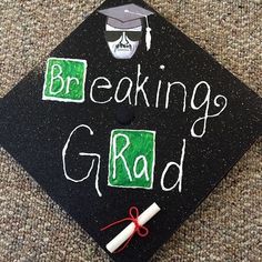 a black graduation cap with the words breaking grad written in white chalk on it