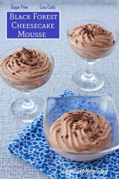 three glasses filled with chocolate cheesecake mousse on top of a blue napkin