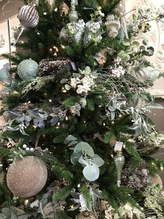 a christmas tree decorated with ornaments and greenery