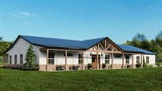 a large white house with a blue roof in the middle of a grassy area next to trees