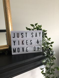 a sign that says just say yikes and move on next to a potted plant