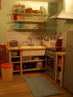 a small kitchen with wooden cabinets and shelves