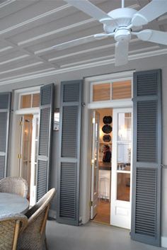 a dining room table with chairs and a ceiling fan