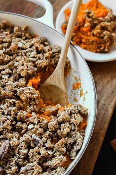 two white bowls filled with granola and carrots