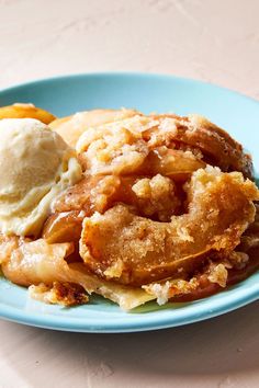 a blue plate topped with apple pie and ice cream