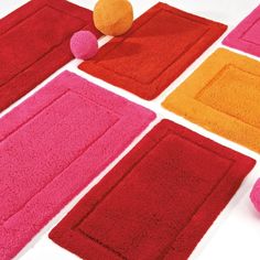 the rugs are all different colors and sizes, but one is pink or orange