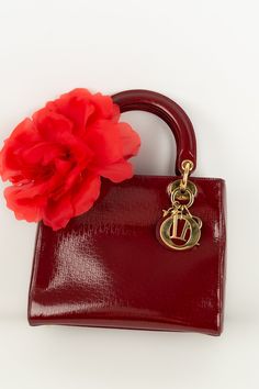 DIOR - Sac à main en cuir vernis rouge et attributs en métal doré. Condition : Bon état Dimensions : Longueur : 19 cm - Hauteur : 23 cm - Profondeur : 9 cm - Anse : 38 cm Trending Handbag, Christian Lacroix, Diaper Backpack, Mode Vintage, Casual Backpack, Lady Dior, Dior Bag, Handbag Accessories, Wallet Case