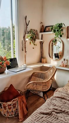 a bedroom with a bed, desk and chair next to a window overlooking the trees