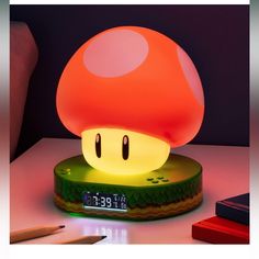 a mushroom shaped lamp sitting on top of a table next to a pencil and ruler