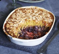 a blueberry cobbler in a white dish on a table