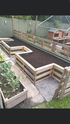 an outdoor vegetable garden with raised beds