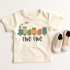 a pair of shoes and a t - shirt with two trains on it