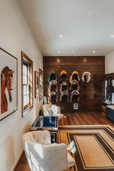 a living room filled with furniture and pictures on the wall next to a horse head