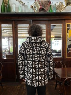 the back of a person standing in front of a display case with musical instruments on it