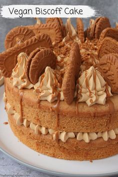 a close up of a cake on a plate with frosting and chocolate cookies in the middle