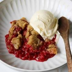 a white plate topped with two scoops of ice cream and a crumb topping