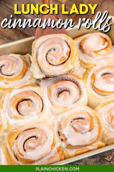 a pan filled with cinnamon rolls on top of a wooden table