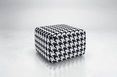 a black and white checkered cube sitting on top of a table