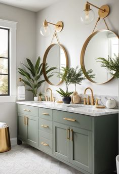 A modern bathroom vanity painted in Sherwin Williams Evergreen Fog with gold hardware and a marble countertop.