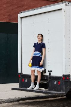 a woman standing in the back of a truck