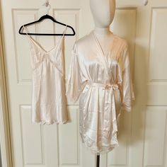 Victoria's Secret Here Come The Bride "Bride" Robe And Matching Nightgown Robe Brand New (Without Tags) Gorgeous White Robe With Bride Embroidered On The Chest In Metallic Gold. Lace Trim On The Hem And On The Sleeves. Belt Tie Around The Waist. Size Extra Small/ Small Length 34 Inches Gorgeous White Nightgown With Criss Cross/ Sexy Back. Lace Trim Underneath The Bust And Goes Down The Sides. Adjustable Straps. Brand New With Tags. However There Is A Very Small Dirt Mark On The Bottom Fro T Of D Victoria's Secret Wedding Night Sleepwear, Victoria's Secret White Dress For Wedding Night, Victoria's Secret Feminine Nightgown For Wedding Night, Victoria's Secret White Sleepwear For Wedding Night, White Victoria's Secret Dress For Loungewear, Victoria's Secret White Lounge Dresses, Elegant Victoria's Secret Sets, Victoria's Secret Satin Sleepwear For Loungewear, White Victoria's Secret Loungewear Dress