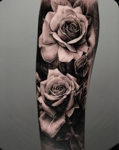 black and white roses tattoo on the arm