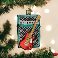 an ornament hanging from a christmas tree with a guitar and sound board on it